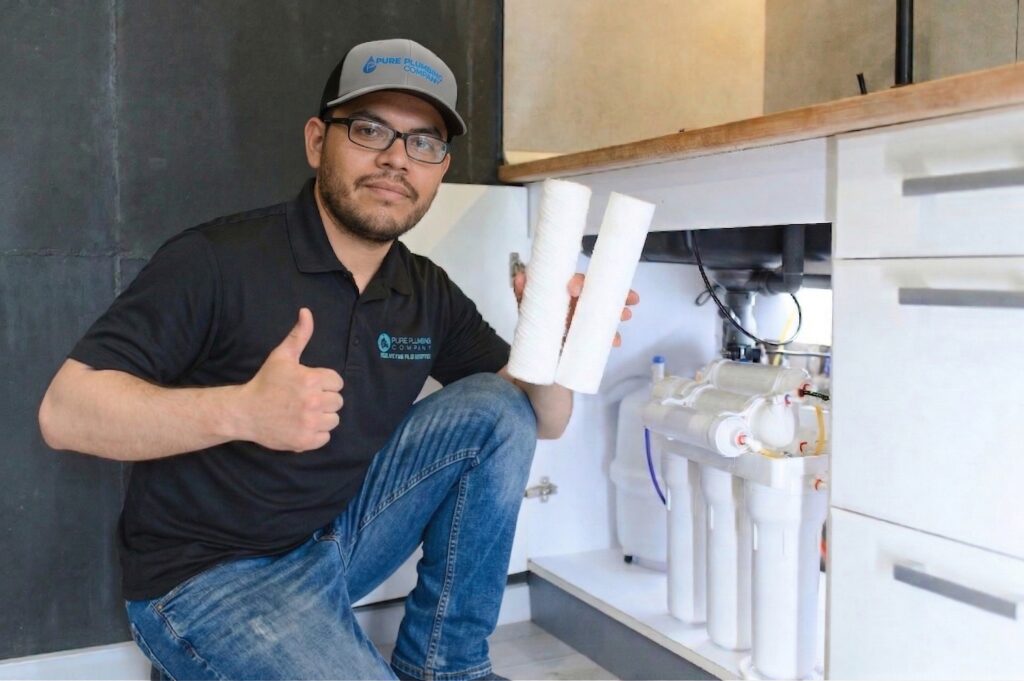 Tech working on water softener system